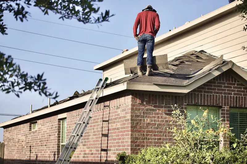 Professional roofer working on a residential roof in Piedmont